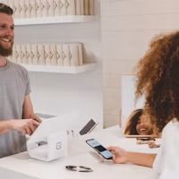 Customer paying at a retail shop counter