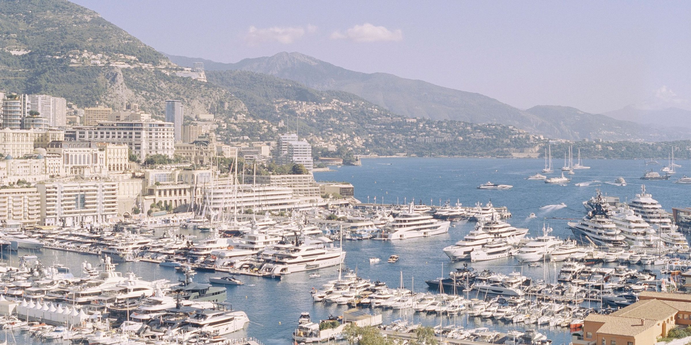 Monaco harbour with luxury yachts, waterfront property and hospitality