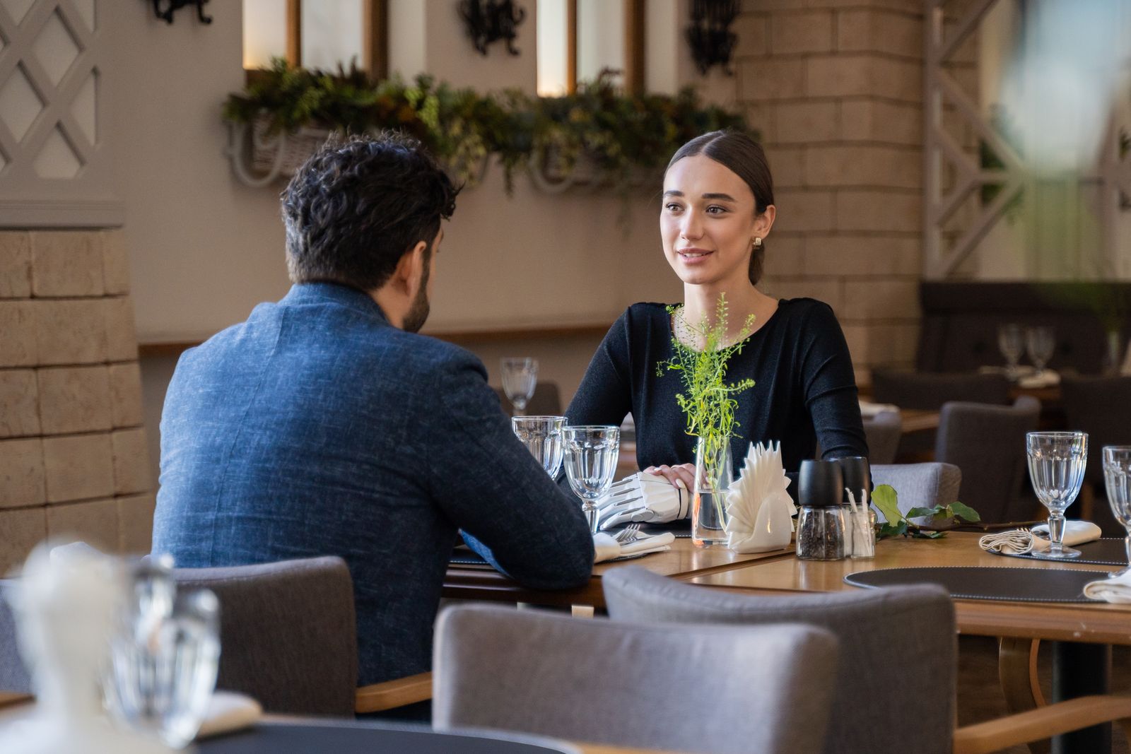 Two business partners in conversation over lunch in a restaurant