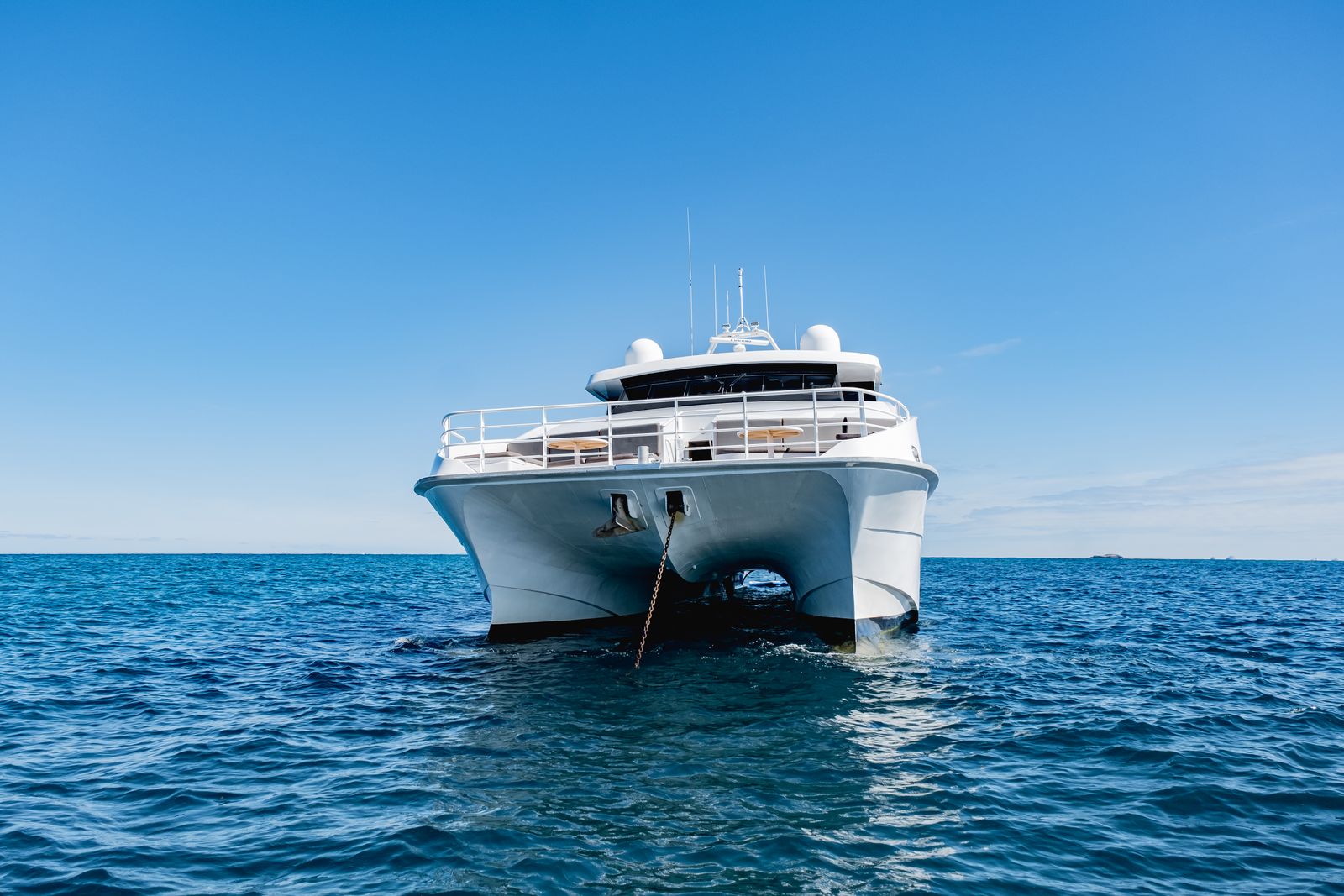 Luxury superyacht at anchor on open blue water
